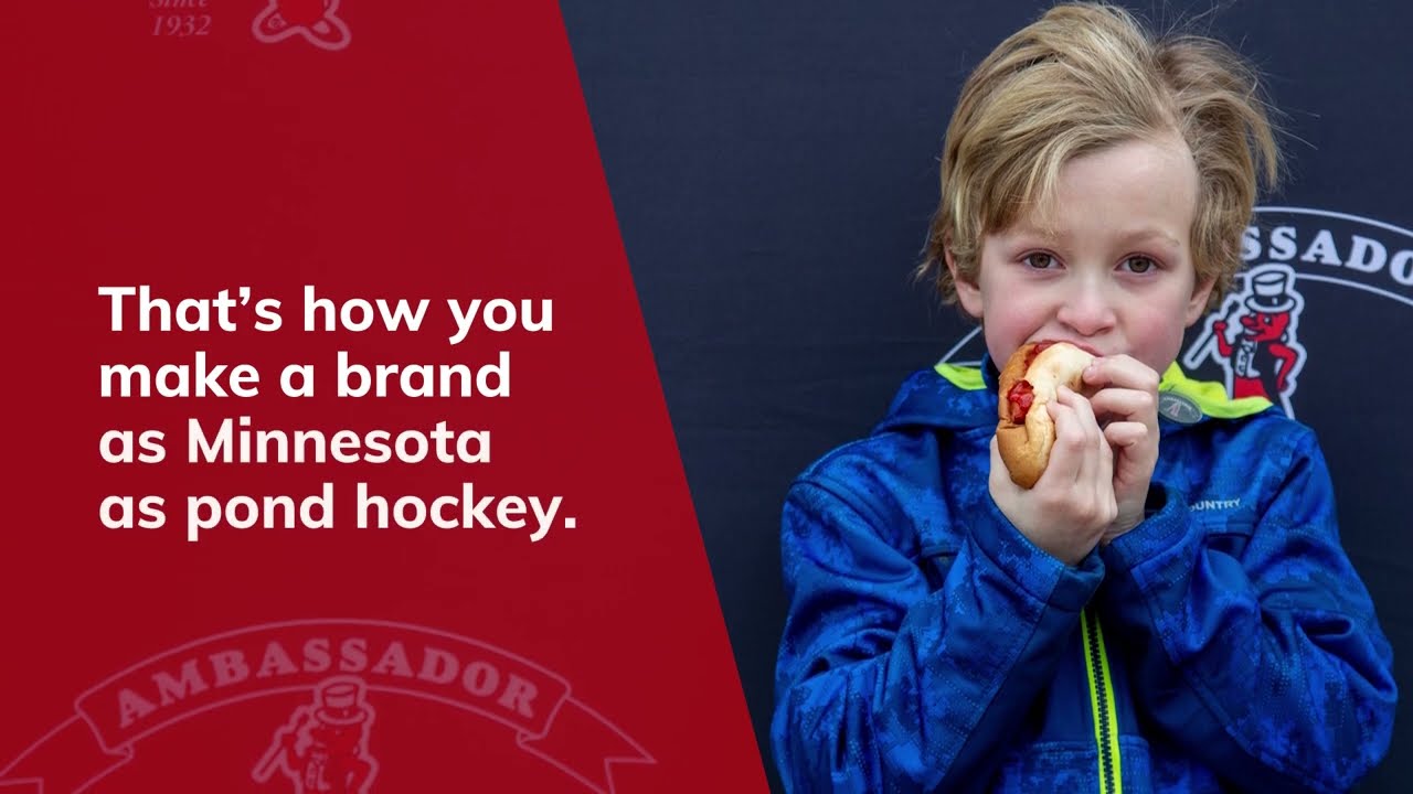 Child eating Ambassador hotdog