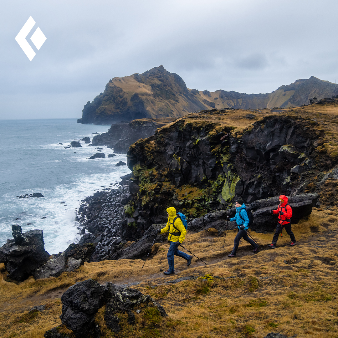 Black Diamond Brand displayin people hiking near coast line