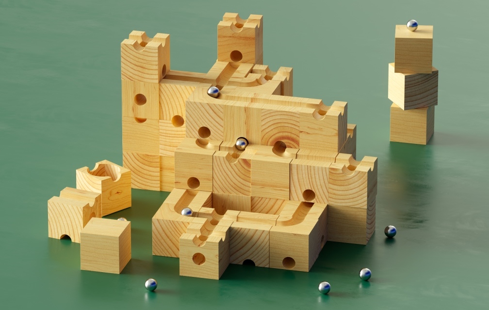 wooden castle puzzle with metal balls falling through the 3D maze they form